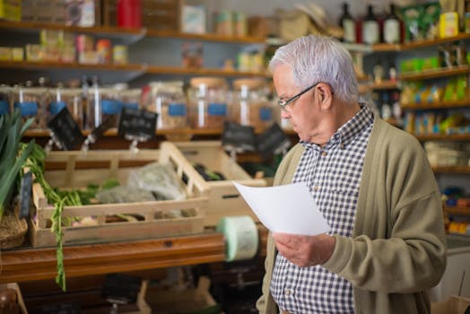Senior man shopping in a Portuguese store, holding a shopping list.
